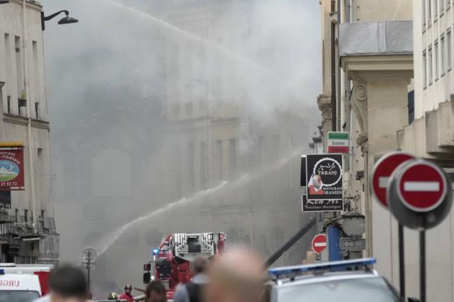 Firemen use a water canon as they fight a blaze Wednesday, June 21, 2023 in Paris. Firefighters fought a blaze on Paris' Left Bank that is sent smoke soaring over the domed Pantheon mo<em></em>nument and prom<em></em>pted evacuation of buildings in the neighborhood, police said. Local media cited witnesses describing a large explosion preceding the fire, and saying that part of a building collapsed. (AP Photo/Christophe Ena)