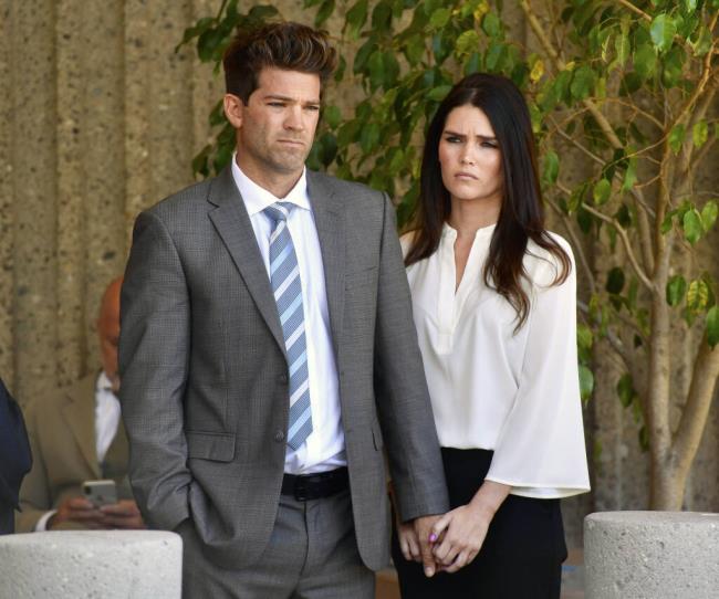 FILE - Dr. Grant Robicheaux and his girlfriend Cerissa Riley listen during a news co<em></em>nference in Newport Beach, Calif., on Oct. 17, 2018. A California judge dismissed sex charges on Friday, July 7, 2023, against a reality TV show doctor and his girlfriend who had been accused of drugging and raping women in a case that drew internatio<em></em>nal attention. Court records show charges of assault with the intent to commit a sexual offense have been dismissed against Dr. Grant Robicheaux and Cerissa Riley. (Paul Bersebach/The Orange County Register via AP, File)