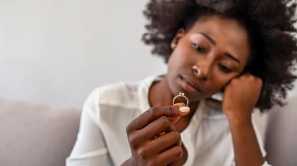 woman co<em></em>ntemplating engaging ring