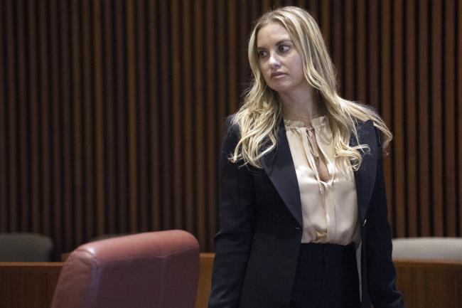 Dr. Katherine Roxanne Grawe, known to her o<em></em>nline followers and patients as "Dr. Roxy," appears before an Ohio Medical Board hearing, Wednesday, July 12, 2023, in Columbus, Ohio. Grawe, an Ohio plastic surgeon, had her state medical license permanently revoked Wednesday after the medical board determined she harmed patients while livestreaming their surgeries on the social media app TikTok. (Courtney Hergesheimer/The Columbus Dispatch via AP)