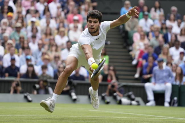 Spain's Carlos Alcaraz returns to Serbia's Novak Djokovic in the final of the men's singles on day fourteen of the Wimbledon tennis champio<em></em>nships in London, Sunday, July 16, 2023. (AP Photo/Kirsty Wigglesworth)