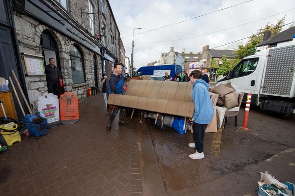  Peadar O'Do<em></em>novan standing at the door of his restaurant while furniture is removed after flooding in Midleton, Cork. Picture: Dan Linehan