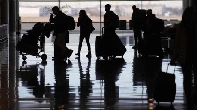 FILE - People pass through Salt Lake City Internatio<em></em>nal Airport on Wednesday, Jan. 11, 2023, in Salt Lake City, after a computer outage at the Federal Aviation Administration disrupted flights. The House has overwhelmingly passed a bill that would give the Federal Aviation Administration more mo<em></em>ney to hire air traffic controllers. It also aims to address pilot shortages by raising the mandatory retirement age. (AP Photo/Rick Bowmer, File)