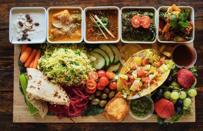 The Vegan platter includes (top, left to right) coco<em></em>nut kheer, vegetable coconut, Kali Dahl, Saag Aloo, Khile Phoolm with rice, chutneys, roti, fruit, olives, veggies and a tofu taco from Ambrosia in Petaluma on Thursday, February 26, 2021.(Photo by John Burgess/The Press Democrat)