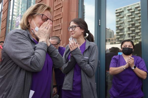 Workers at a family planning clinic in Chicago get emotio<em></em>nal as thousands of abortion rights demo<em></em>nstrators march past their clinic chanting their support.