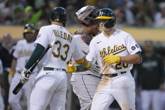 The Athletics’ Zack Gelof, right, is co<em></em>ngratulated by JJ Bleday (after hitting a home run during the seventh inning against the Houston Astros in Oakland, Saturday, July 22, 2023. (Jeff Chiu / ASSOCIATED PRESS)