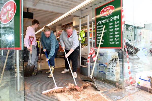  Breda Sisk and Fio<em></em>nnula Coakley clearing flood water from the Homesavers store on Main St, Midleton, Co Cork, in the wake of the Storm Babet flood. Picture: Larry Cummins
