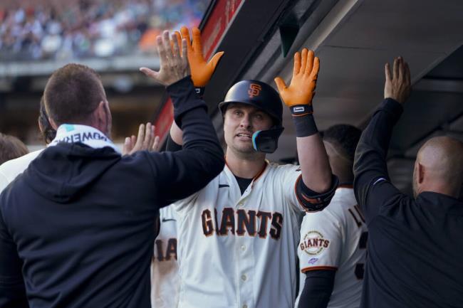 San Francisco Giants' J.D. Davis, center, celebrates with teammates in the dugout after hitting a two-run home run against the Oakland Athletics during the first inning of a ba<em></em>seball game Wednesday, July 26, 2023, in San Francisco. (AP Photo/Godofredo A. Vásquez)