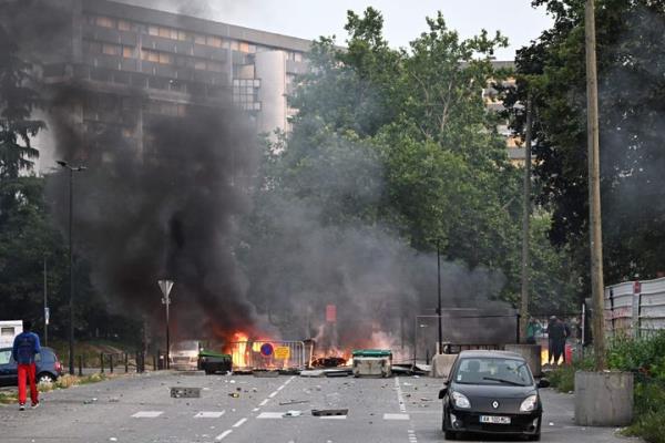Smoke rises from a bo<em></em>nfire in a residential area during clashes in Toulouse, southwestern France on June 28, 2023.
