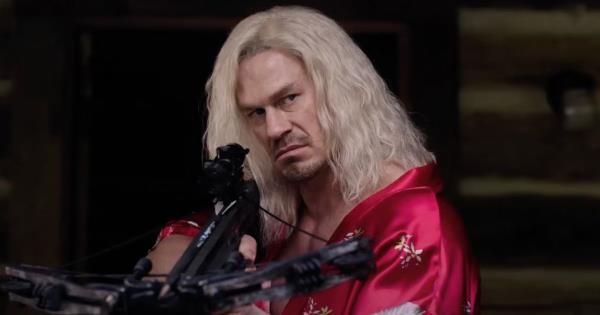 John Cena with long blo<em></em>nde hair holding a crossbow in Die Hart 2 on Roku