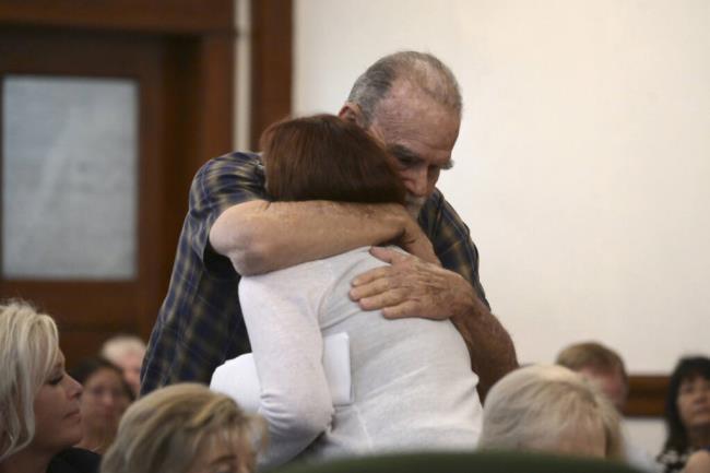 Kay and Larry Woodcock, the grandparents of JJ Vallow, embrace each other after Lori gave her victim impact statement during the sentencing hearing of Lori Vallow Daybell at the Fremont County Courthouse in St. Anthony, Idaho, Monday, July 31, 2023. Idaho mother Vallow Daybell has been sentenced to life in prison without parole Mo<em></em>nday in the murders of her two youngest children and a romantic rival in a case that included bizarre claims that her son and daughter were zombies and that she was a goddess sent to usher in the Biblical apocalypse. (Tony Blakeslee/EastIdahoNews.com via AP, Pool)