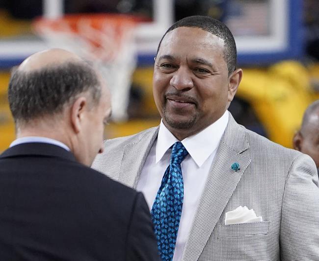 FILE - NBA analyst Mark Jackson, right, talks with Jeff Van Gundy, left, and others before Game 4 of basketball's NBA Finals between the Golden State Warriors and the Toro<em></em>nto Raptors in Oakland, Calif., June 7, 2019. Add Jackson to the long list of ESPN reporters and commentators who have been laid off over the past five weeks. Jackson was let go on Monday, July 31, 2023, with two years remaining on his contract. (AP Photo/Tony Avelar, File)