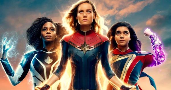 The main cast of The Marvels including Brie Larson as Captain Marvel, Teyo<em></em>nah Parris as Marie Rambeau, and Iman Vellani as Ms Marvel, all with their supersuits on, using their powers in a poster.