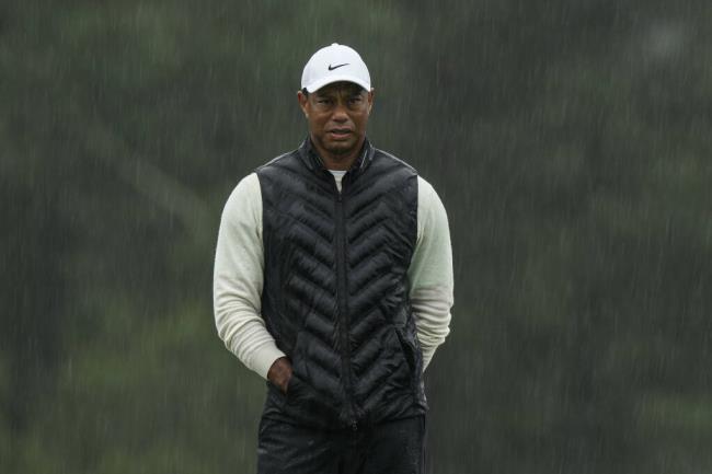 Tiger Woods walks on the 18th hole during the weather delayed second round of the Masters golf tournament at Augusta Natio<em></em>nal Golf Club on Saturday, April 8, 2023, in Augusta, Ga. (AP Photo/Charlie Riedel)