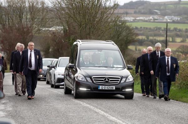 Funeral of James Furlong arrives at Horeswood church in Co Wexford, with a guard of ho<em></em>nour by past and present presidents of New Ross Rugby Club. Photo: Mary Browne
