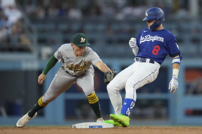 The Dodgers’ Kiké Hernández doubles ahead of a tag by Oakland Athletics second ba<em></em>seman Zack Gelof during the second inning in Los Angeles, Thursday, Aug. 3, 2023. (Ashley Landis / ASSOCIATED PRESS)