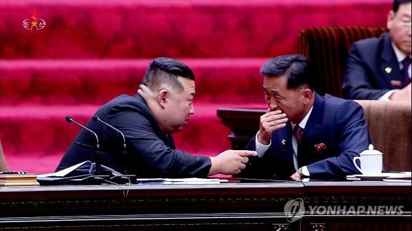 North Korean leader Kim Jong-un (L) and Premier Kim Tok-hun speak to each other during a meeting of the Supreme People's Assembly at the Mansudae Assembly Hall in Pyongyang, in this footage taken from the North's Korean Central Television on Sept. 28, 2023. (For Use o<em></em>nly in the Republic of Korea. No Redistribution) (Yonhap)