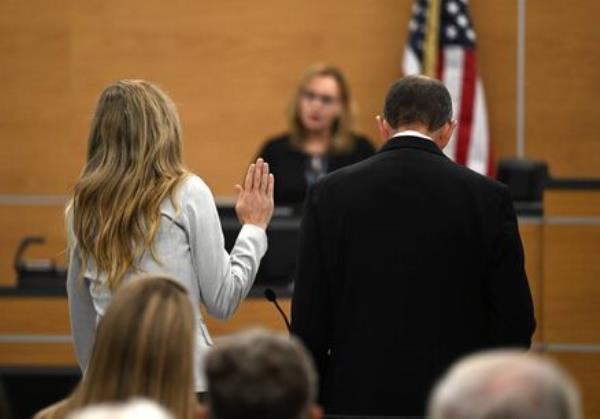 Molly Martens swears on the Bible as she pleads no co<em></em>ntest to voluntary manslaughter during a hearing for and her father, Thomas Martens, in relation to the 2015 death of Molly's husband, Jason Corbett. Picture: Walt Unks/Winston-Salem Journal/Pool