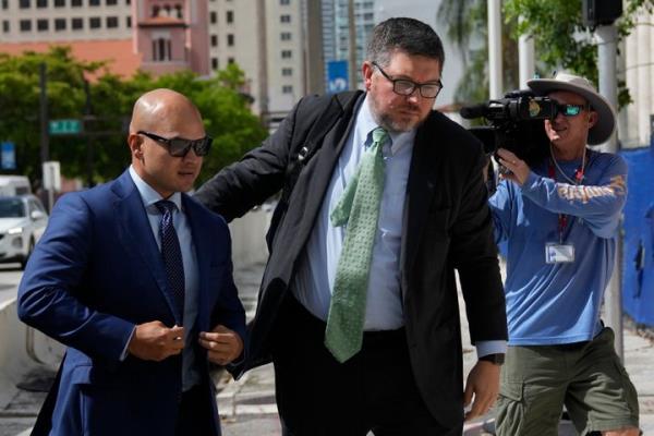 Walt Nauta, left, a valet to former President Do<em></em>nald Trump who is charged with helping the ex-president hide classified docu<em></em>ments the Justice Department wanted back, arrives for his arraignment along with defense attorney Stanley Woodward, at the James Lawrence King Federal Justice Building in Miami, Thursday, July 6, 2023. (AP Photo/Rebecca Blackwell)
