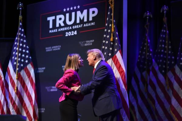 Former President Do<em></em>nald Trump is greeted by Iowa Gov. Kim Reynolds as he arrives for an event at the Adler Theatre on March 13, 2023, in Davenport, Iowa. Trump's visit follows those by potential challengers for the GOP presidential nomination, Florida Gov. Ron DeSantis and former U.N. Ambassador Nikki Haley, who hosted events in the state last week. 