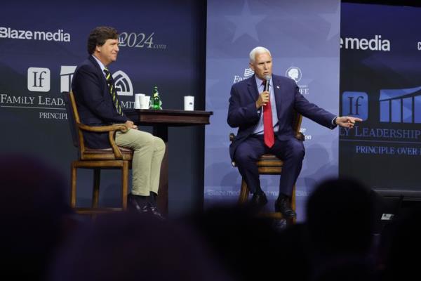 Former Vice President Mike Pence fields questions from former Fox News perso<em></em>nality Tucker Carlson on July 14, 2023, in Des Moines, Iowa. Several Republican presidential candidates were scheduled to speak at the event, billed as “The Midwest’s largest gathering of Christians seeking cultural transformation in the family, Church, government, and more.”