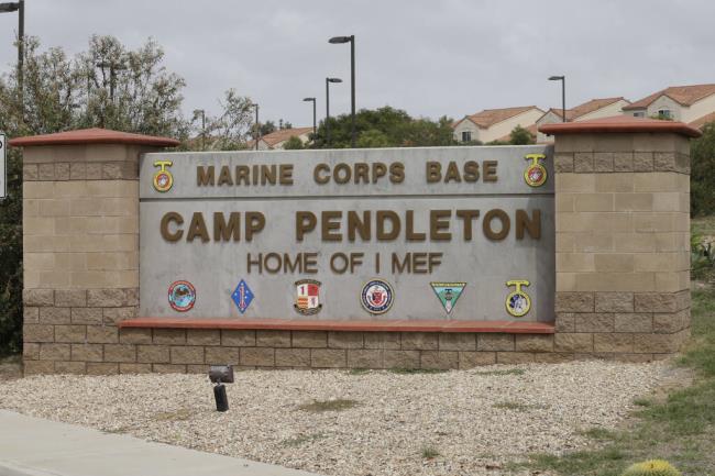 FILE - The entrance to Marine Corps ba<em></em>se Camp Pendleton is seen on Sept. 22, 2015, in Oceanside, Calif. A Camp Pendleton Marine was detained for questio<em></em>ning after military police found a 14-year-old girl on ba<em></em>se June 28, 2023. The girl's grandmother in San Diego reported her missing June 13. (AP Photo/Gregory Bull, File)