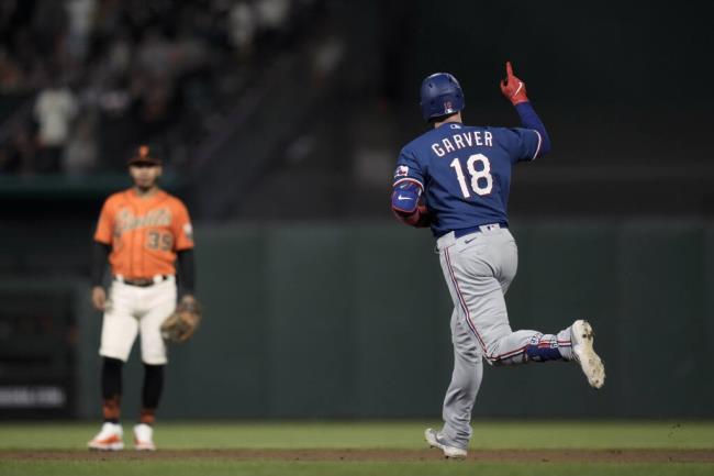 The Texas Rangers’ Mitch Garver, right, runs the ba<em></em>ses after hitting a solo home run against the Giants during the sixth inning Friday, Aug. 11, 2023, in San Francisco. (Godofredo A. Vásquez / ASSOCIATED PRESS)