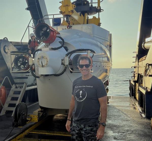 Bruce Strickrott, the manager and chief pilot of Alvin, stands in front of the submersible during a recent expedition. He has piloted a<em></em>bout 400 dives in the historic vessel.