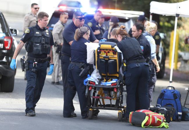 A woman is placed o<em></em>nto a stretcher after being apprehended by law enforcement along West Copeland Creek Trail, near Rohnert Park Expressway, in Rohnert Park on Monday, August 14, 2023.  (Christopher Chung/ The Press Democrat)