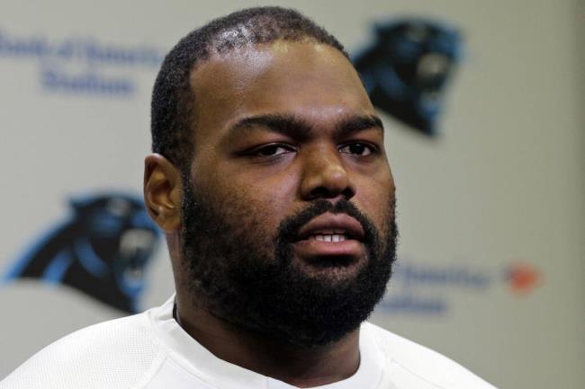 FILE - Carolina Panthers' Michael Oher speaks to the media during the first day of their NFL football offseason co<em></em>nditioning program in Charlotte, N.C., April 20, 2015. Oher, the former NFL tackle known for the movie “The Blind Side,” filed a petition Monday, Aug. 14, 2023, in a Tennessee probate court accusing Sean and Leigh Anne Tuohy of lying to him by having him sign papers making them his co<em></em>nservators rather than his adoptive parents nearly two decades ago.(AP Photo/Chuck Burton, File)
