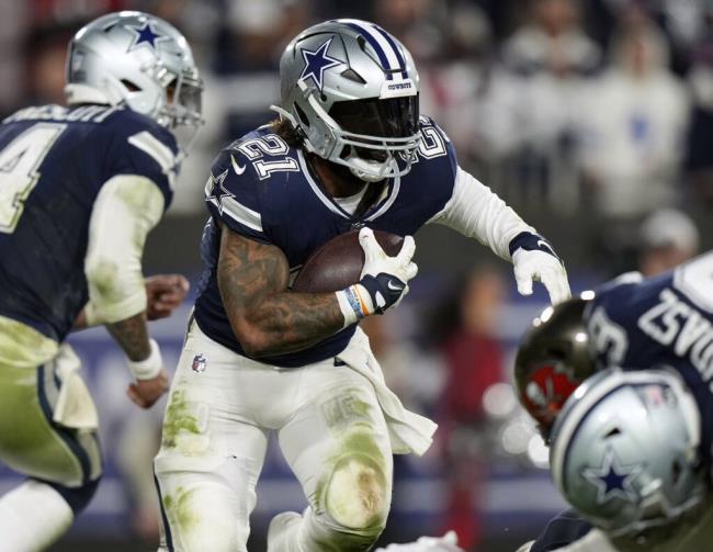 FILE - Dallas Cowboys running back Ezekiel Elliott (21) looks for running room as he rushes with the ball during an NFL wild-card football game against the Tampa Bay Buccaneers, Jan. 16, 2023, in Tampa, Fla. A person familiar with the terms tells The Associated Press that three-time Pro Bowl running back Elliott has signed a one-year deal with the New England Patriots worth $4 million. The person spoke on co<em></em>ndition of ano<em></em>nymity because the team has not announced the move. (AP Photo/Peter Joneleit, File)