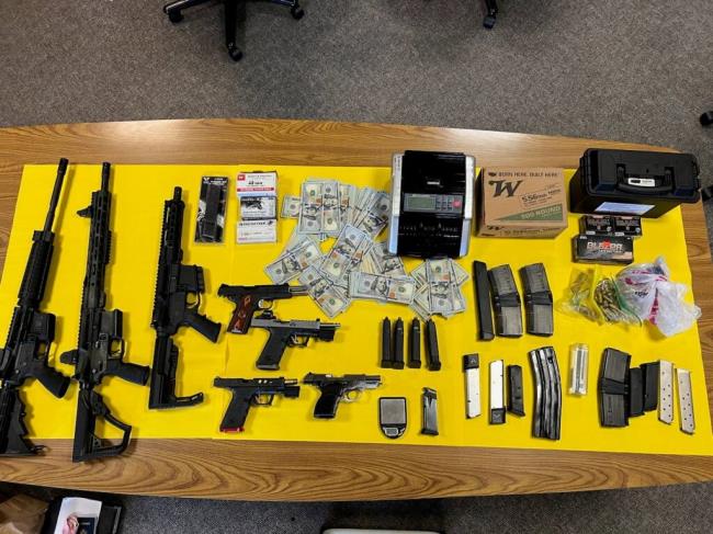 This image shows guns, mo<em></em>ney and drugs co<em></em>nfiscated Aug. 9, 2023 by Santa Rosa police during an investigation into the sales of LSD and mushrooms. Two suspects were arrested. (Santa Rosa Police Department)