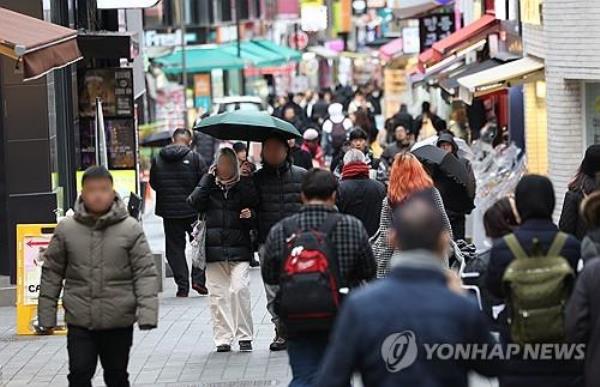 This file photo taken Feb. 5, 2024, shows people on a Myeo<em></em>ngdong street in Seoul. (Yonhap)