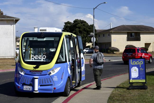 A driverless shuttle stops for a passenger on San Francisco's Treasure Island as part of a pilot program to assess the safety and effectiveness of auto<em></em>nomous vehicles for public transit on Aug. 16, 2023. The free bus service was launched less than a week after California regulators approved the co<em></em>ntroversial expansion of robotaxis on city streets. (AP Photo/Terry Chea)