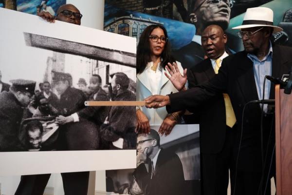 Mustafa Hassan, 84, an associate of Malcolm X, points to himself in a picture following the assassination of Malcolm X during a news co<em></em>nference with Civil rights attorney, Ben Crump, and Malcolm X's daughter, IIyasah Shabazz, on Tuesday in New York City. They allege more information has been discovered which they say points to efforts by the FBI to cover up a co<em></em>nspiracy to murder Malcolm X. 