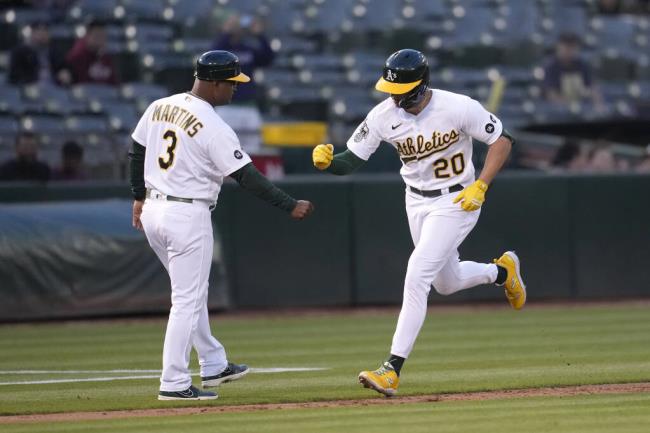 Oakland Athletics' Zack Gelof (20) is co<em></em>ngratulated by third ba<em></em>se coach Eric Martins (3) after hitting a home run against the Kansas City Royals during the third inning of a ba<em></em>seball game in Oakland, Calif., Monday, Aug. 21, 2023. (AP Photo/Jeff Chiu)