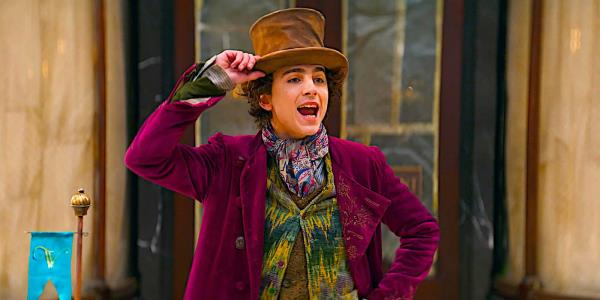 Timothee Chalamet giving a speech while holding his hat as Willy Wo<em></em>nka in a scene from Wonka