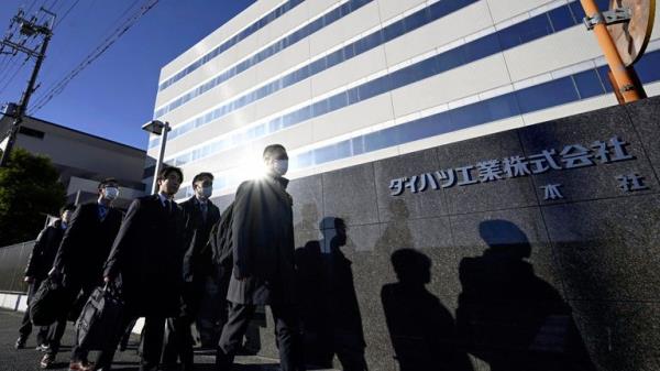 Japanese transport ministry officials arrive for the headquarters of Daihatsu Motor in Ikeda, Osaka, Thursday, Dec. 21, 2023. Japanese transport ministry officials inspected Toyota subsidiary Daihatsu on Thursday, one day after officials announced it was suspending the small car unit<em></em>'s shipments of all vehicles in and outside Japan after an investigation found improper testing involving 64 models.  (Kyodo News via AP)