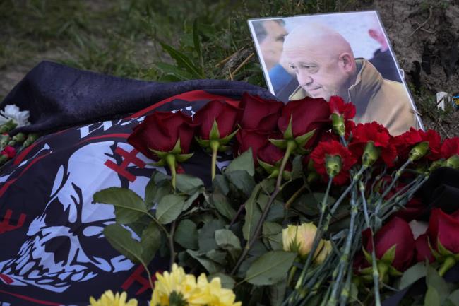 A portrait of the owner of private military company Wagner Group Yevgeny Prigozhin lays at an informal memorial next to the former 'PMC Wagner Centre' in St. Petersburg, Russia, Thursday, Aug. 24, 2023. Russia's civil aviation agency says mercenary leader Yevgeny Prigozhin was aboard a plane that crashed north of Moscow. (AP Photo/Dmitri Lovetsky)