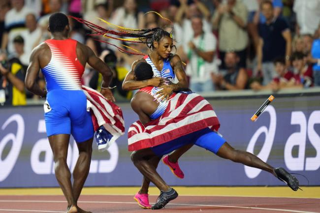 Sha’Carri Richardson of the United States is greeted by members of the U.S. men’s team as she celebrates anchoring her team to gold in the women’s 4x100-meter relay final during the World Athletics Champio<em></em>nships in Budapest, Hungary, Saturday, Aug. 26, 2023. (Petr David Josek / ASSOCIATED PRESS)