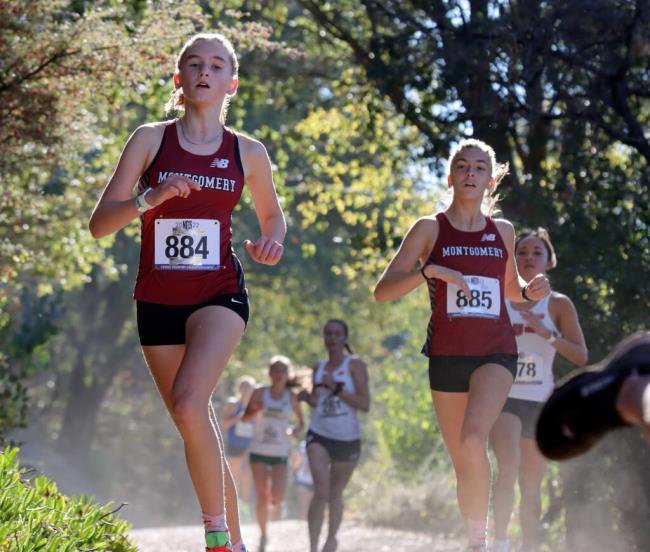 Seelah Kittlestrom (884) and Amrie Lacefield (885), both of Mo<em></em>ntgomery run in the Division 3 Girls race during the CIF North Coast Section Cross Country Champio<em></em>nships at Hayward High School, Saturday, November 19, 2022, in Hayward. (Darryl Bush / For The Press Democrat)