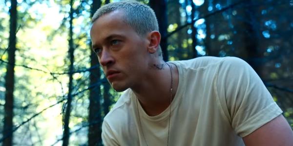 Tom Blyth as Coriolanus Snow looking pensive in a white T-Shirt in The Hunger Games The Ballad of So<em></em>ngbirds and Snakes