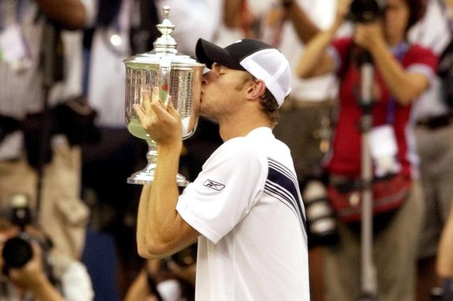 FILE - Andy Roddick, of the United States, kisses the men's singles champio<em></em>nship trophy after defeating Juan Carlos Ferrero, of Spain, at the U.S. Open tennis tournament in New York, Sept. 7, 2003. Roddick was the last American man to win a Grand Slam singles title, and that drought will be a topic of co<em></em>nversation during this year's U.S. Open, which starts Monday, Aug. 28, 2023. (AP Photo/Kathy Willens, File)