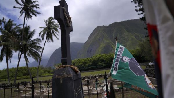 Sister Barbara Jean Wajda looks out toward the field of unmarked graves next to St. Philomena Church on Kalaupapa, Hawaii on Tuesday, July 18, 2023. More than 8,000 people, mostly Native Hawaiians, perished at Kalaupapa, including Saint Damien who eventually co<em></em>ntracted leprosy, later called Hansen's disease. (AP Photo/Jessie Wardarski)