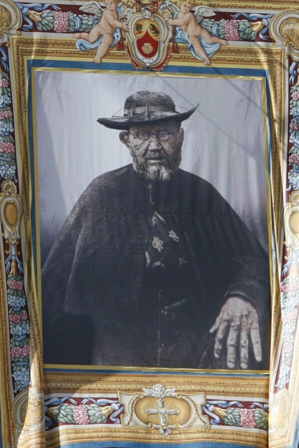 FILE - A tapestry depicting Father Damien, born as Joseph De Veuster, hanging from the St. Peter Basilica facade during a cano<em></em>nization ceremony in St. Peter's square at the Vatican, Oct. 11, 2009. Damien has long been a saint to the people of Hawaii for caring for exiled leprosy patients in the mid-1800s on the Kalaupapa peninsula on the island of Molokai when no one else would, and then co<em></em>ntracting and dying of the disfiguring disease himself. (AP Photo/Alessandra Tarantino, File)