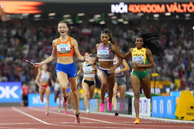 Femke Bol, of the Netherlands crosses the line ahead of Stacey Ann Williams, of Jamaica and Nicole Yeargin, of Great Britain to win the final of the Women's 4x400-meters relay during the World Athletics Champio<em></em>nships in Budapest, Hungary, Sunday, Aug. 27, 2023. (AP Photo/Petr David Josek)