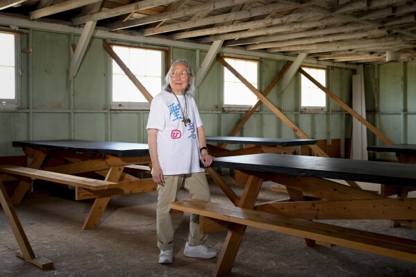 Sally Nakai Kobayashi, who was born at Minidoka in April of 1945, poses for a portrait in an original mess hall building similar to one her mother worked in at Minidoka Natio<em></em>nal Historic Site, Saturday, July 8, 2023, in Jerome, Idaho. Kobayashi was visiting the site with her younger sister and son for the first time since 1945, when the camp closed following the end of World War II. (AP Photo/Lindsey Wasson)