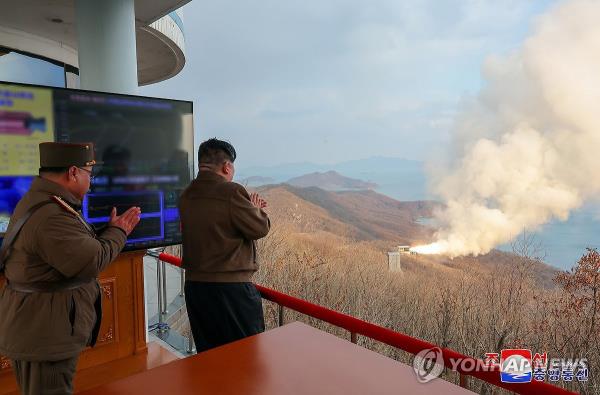 North Korean leader Kim Jong-un (R) attends a ground jet test of a solid-fuel engine for a new type of intermediate-range hyperso<em></em>nic missile at the Sohae Satellite Launching Ground on March 19, 2024, in this photo carried by the Korean Central News Agency the next day. (For Use o<em></em>nly in the Republic of Korea. No Redistribution) (Yonhap)