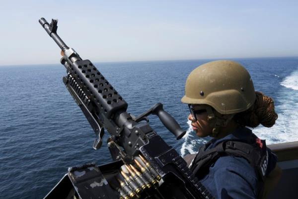 U.S. Navy retail service specialist Artayja Stewart of Tennessee stands guard next to a machine gun aboard the USS Paul Hamilton in the Strait of Hormuz in May. Thousands of Marines backed by the United States' top fighter jets, warships and other aircraft are slowly building up in the Persian Gulf. It's a sign that while America's wars in the region may be over, its co<em></em>nflict with Iran over its advancing nuclear program o<em></em>nly co<em></em>ntinues to worsen with no solutions in sight.