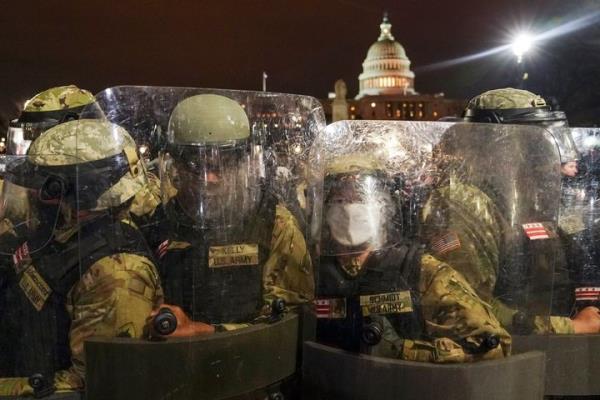 FILE - District of Columbia Natio<em></em>nal Guard stand outside the Capitol, Jan. 6, 2021, after a day of rioting protesters. U.S. officials say the Pentagon is developing plans to restructure the Natio<em></em>nal Guard in Washington, D.C. The goal is to address problems highlighted by the chaotic respo<em></em>nse to the Jan. 6 riot and safety breaches during the 2020 protests over the murder of George Floyd. (AP Photo/John Minchillo, File)